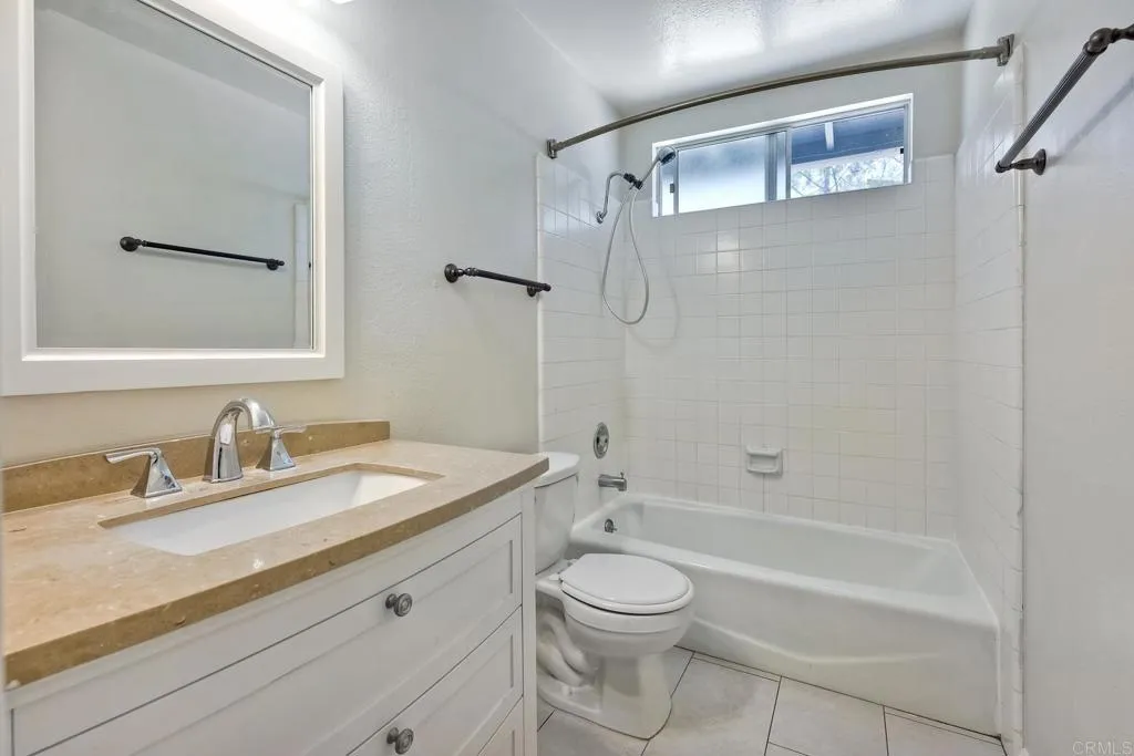 2425 Torrejon Place Carlsbad, CA 92009 - Photo 17 of 61 a bathroom with a granite countertop sink a toilet and shower