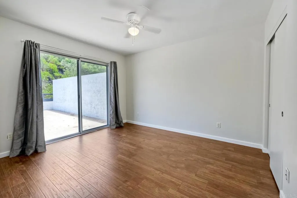 2425 Torrejon Place Carlsbad, CA 92009 - Photo 18 of 61 wooden floor in an empty room with a window