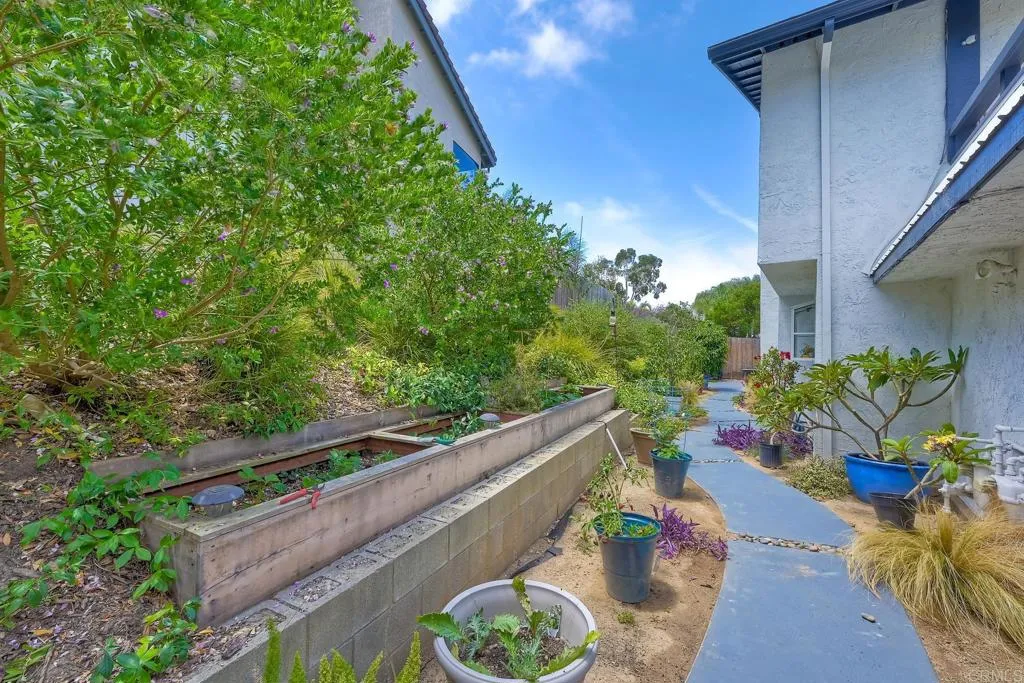 2425 Torrejon Place Carlsbad, CA 92009 - Photo 20 of 61 a view of a chairs and table in a backyard