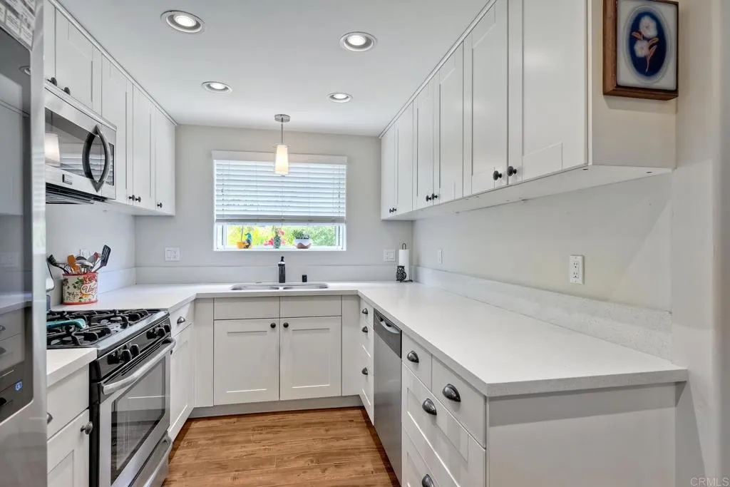 2425 Torrejon Place Carlsbad, CA 92009 - Photo 24 of 61 a kitchen that has a sink and a stove
