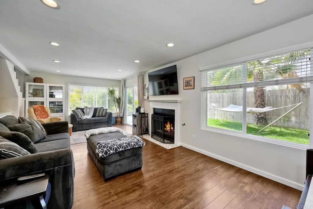 2425 Torrejon Place Carlsbad, CA 92009 - Photo 26 of 61 a living room with furniture a large window and a fireplace