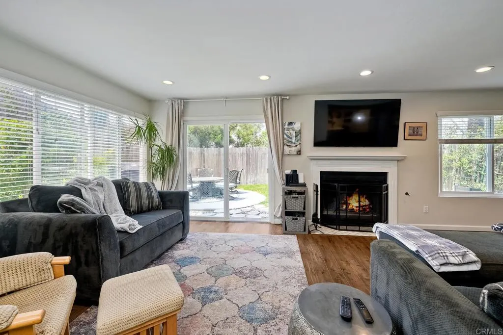 2425 Torrejon Place Carlsbad, CA 92009 - Photo 29 of 61 a living room with furniture a flat screen tv and a fireplace