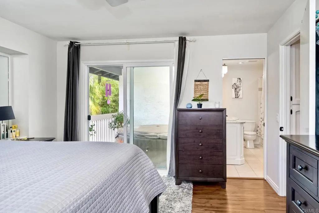 2425 Torrejon Place Carlsbad, CA 92009 - Photo 35 of 61 a bedroom with a bed and wooden floor