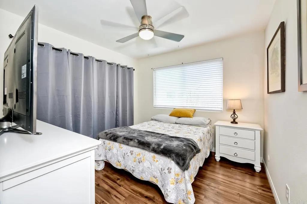 2425 Torrejon Place Carlsbad, CA 92009 - Photo 39 of 61 a bedroom with a bed and a chandelier