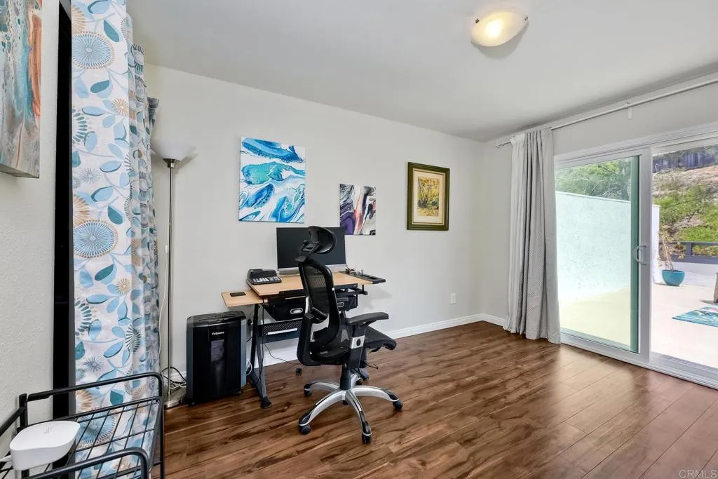 2425 Torrejon Place Carlsbad, CA 92009 - Photo 43 of 61 a view of a workspace with wooden floor and a window