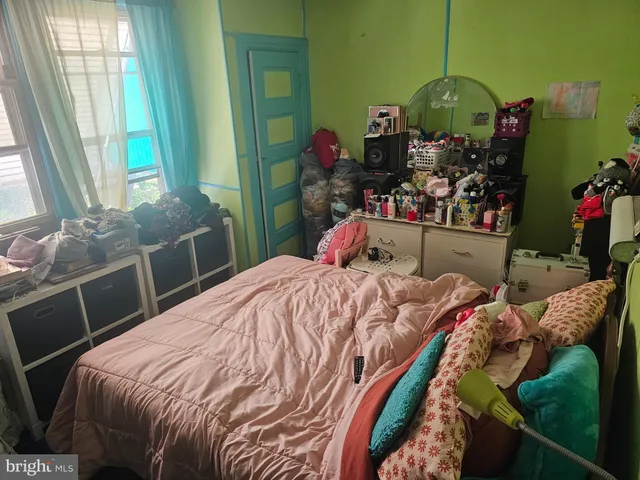 a bed sitting in a bedroom next to a window