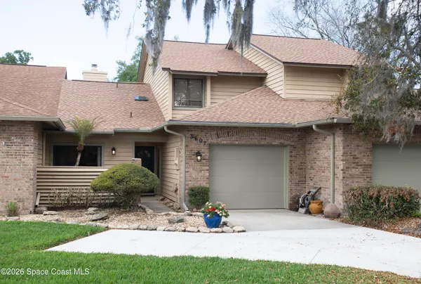 a view of a house with backyard and sitting area