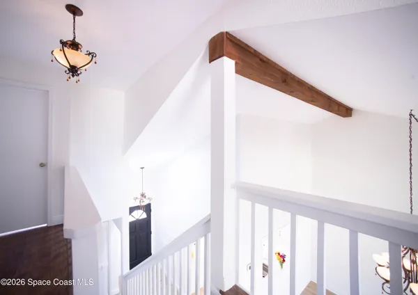 a view of a room with wooden floor and cabinet