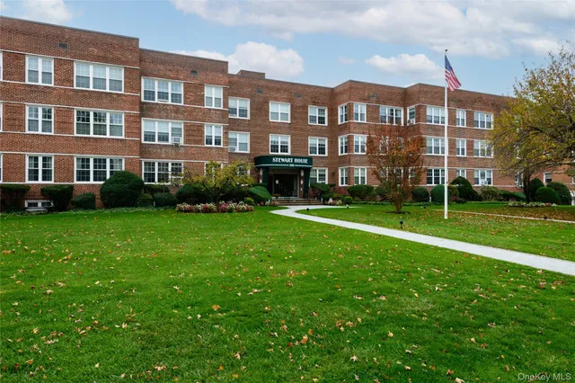 a front view of a building with a yard