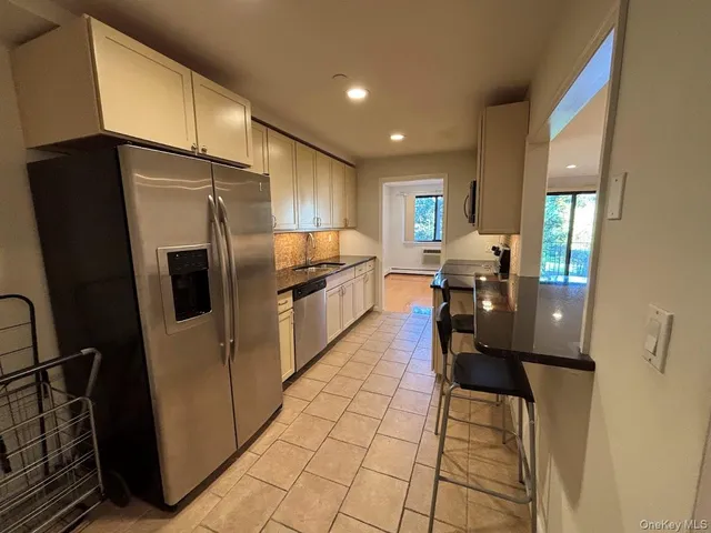 a kitchen with stainless steel appliances granite countertop a sink and cabinets
