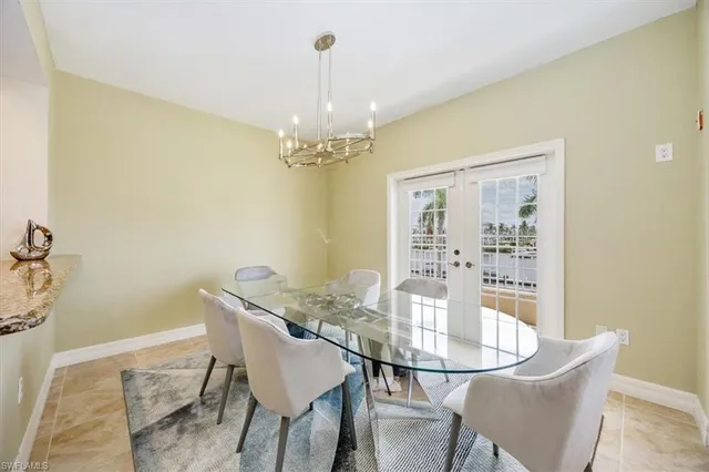 a dining room with furniture and chandelier