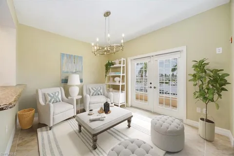 a living room with furniture potted plant and a chandelier