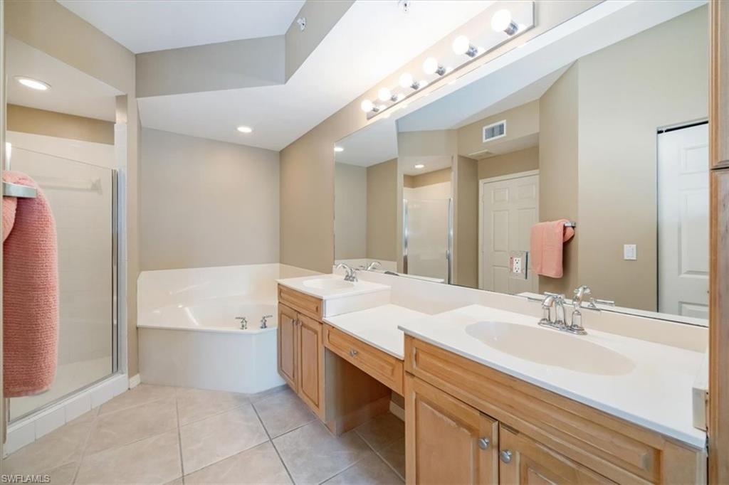 451 Bayfront Place, Unit 5207 Naples, FL 34102 - Photo 15 of 35 a spacious bathroom with a double vanity sink a mirror and a bathtub