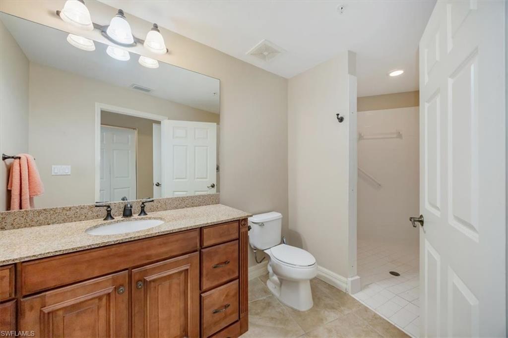 451 Bayfront Place, Unit 5207 Naples, FL 34102 - Photo 17 of 35 a bathroom with a sink a toilet and shower