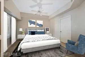 a bedroom with a large bed and a chandelier