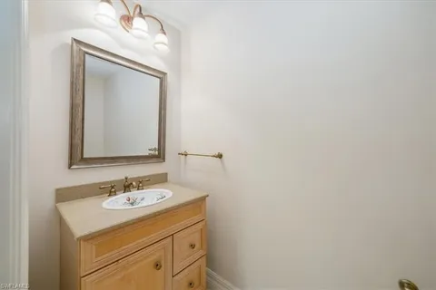 a bathroom with a sink vanity and a mirror