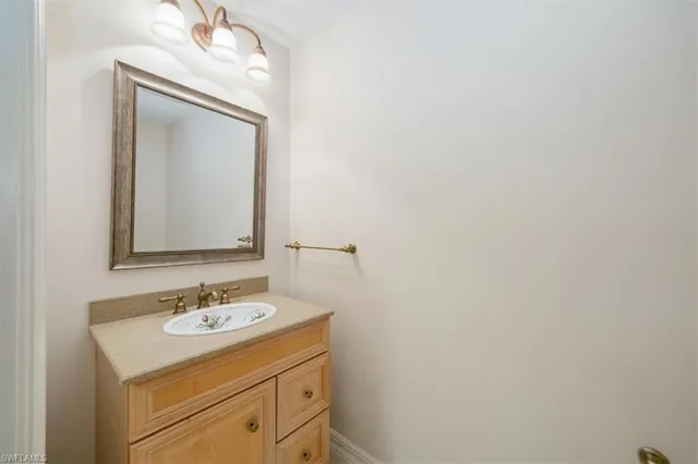 a bathroom with a sink vanity and a mirror