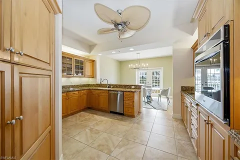 a large kitchen with a large counter top appliances and cabinets