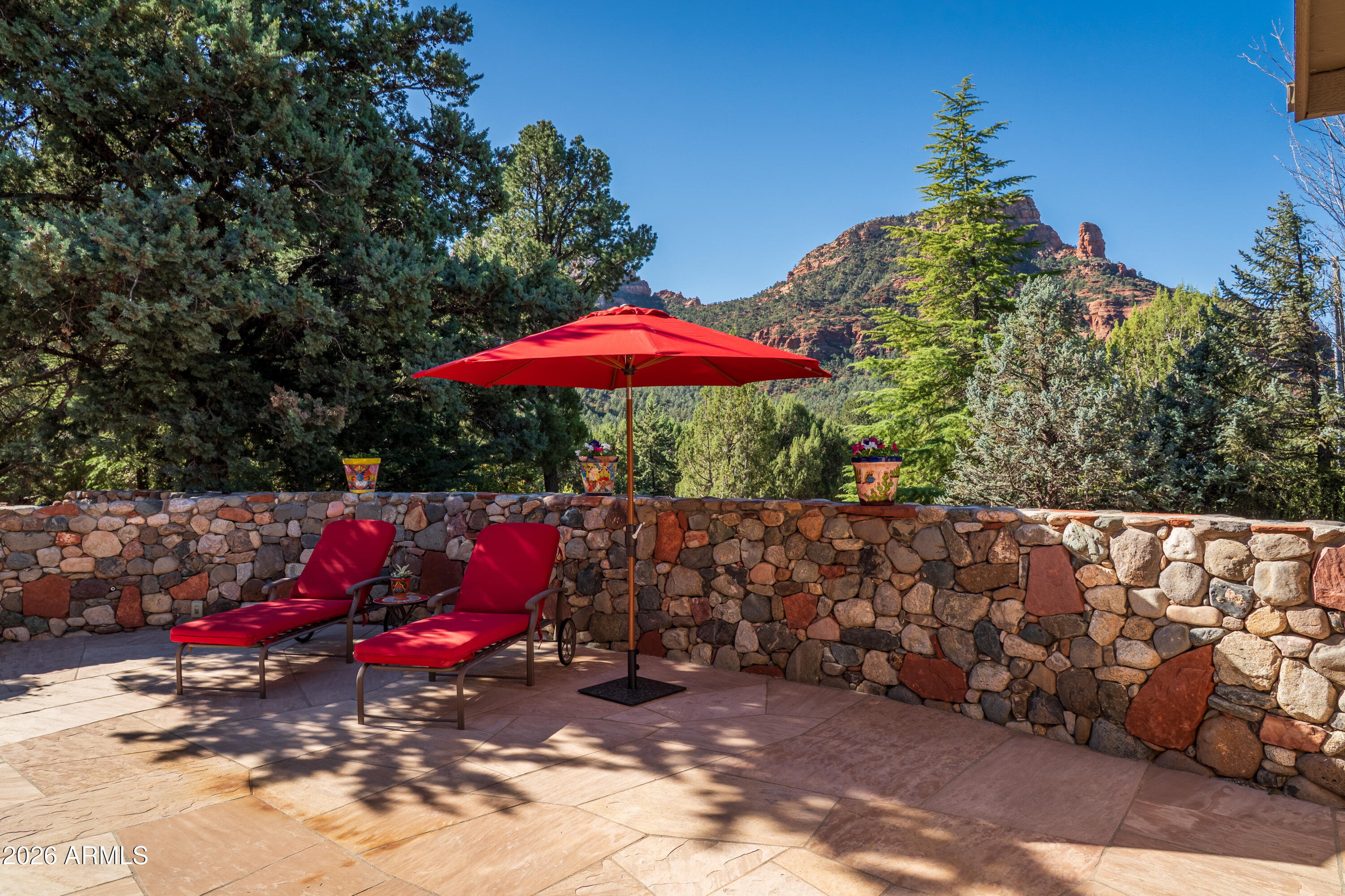 190 Morgan Road Sedona, AZ 86336 - Photo 15 of 51 an outdoor sitting area with red umbrella