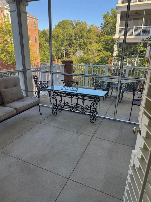 591 Lexington Road, Unit 201 Memphis, TN 38117 - Photo 9 of 11 a view of a patio with a table and chairs