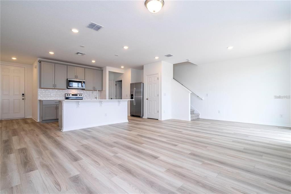 4549 Burrowing Owl Loop St. Cloud, FL 34772 - Photo 15 of 48 a view of kitchen with kitchen island microwave and cabinets