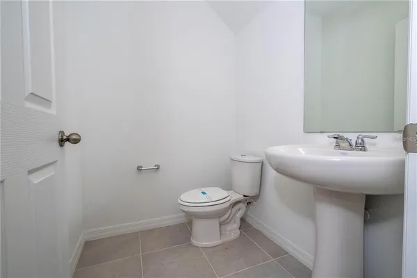 a bathroom with a sink toilet and a mirror