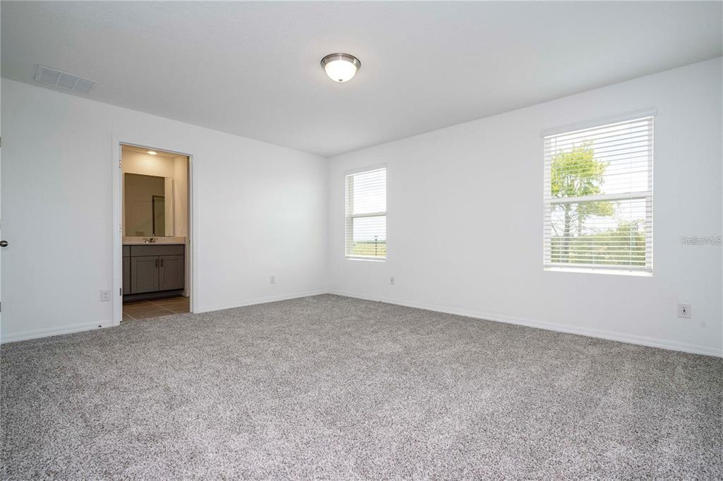 4549 Burrowing Owl Loop St. Cloud, FL 34772 - Photo 20 of 48 an empty room with windows