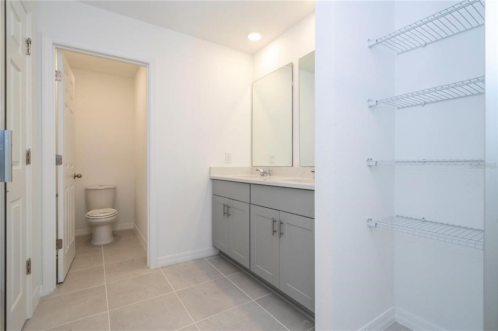 4549 Burrowing Owl Loop St. Cloud, FL 34772 - Photo 22 of 48 a spacious bathroom with a granite countertop sink toilet and shower