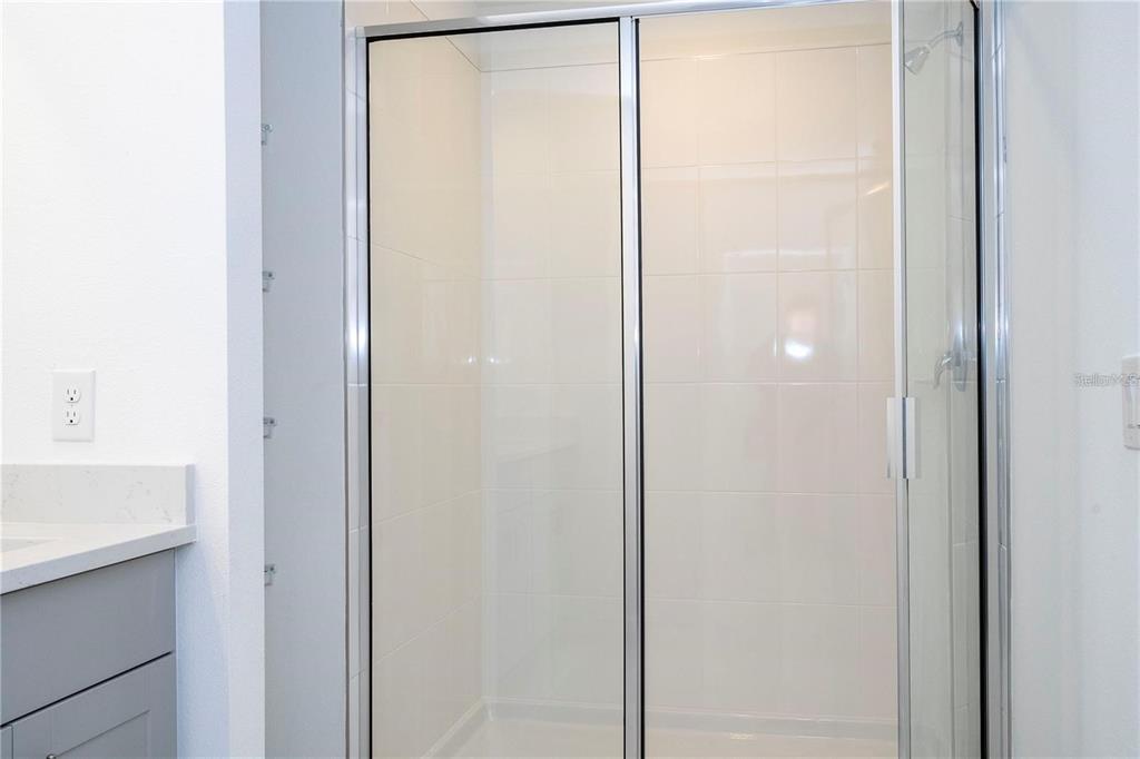 4549 Burrowing Owl Loop St. Cloud, FL 34772 - Photo 26 of 48 a bathroom with a shower and a sink