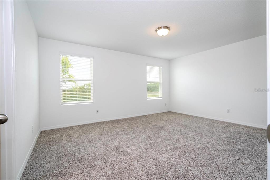4549 Burrowing Owl Loop St. Cloud, FL 34772 - Photo 29 of 48 an empty room with windows