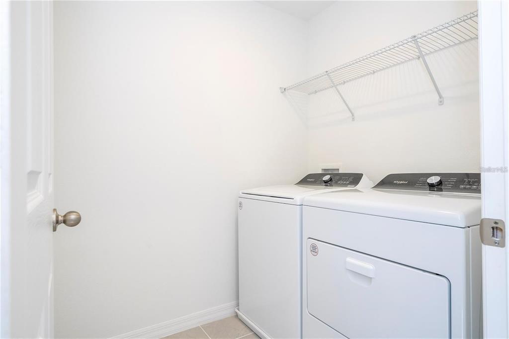4549 Burrowing Owl Loop St. Cloud, FL 34772 - Photo 30 of 48 a utility room with dryer and washer