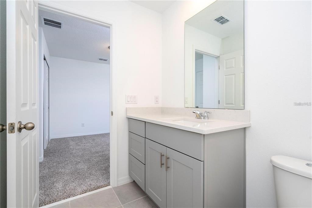 4549 Burrowing Owl Loop St. Cloud, FL 34772 - Photo 32 of 48 a bathroom with a sink and a mirror