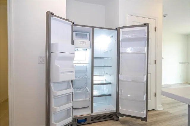 a bathroom with a glass shower door and a mirror