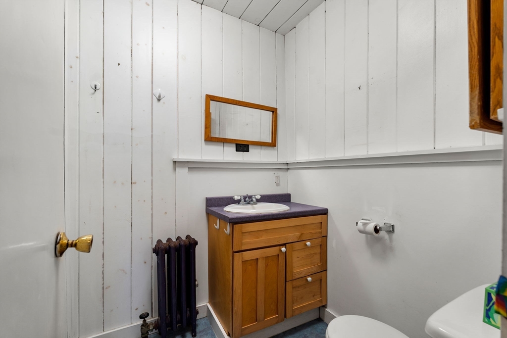 104 Mill Street Groton, MA 01450 - Photo 14 of 30 a bathroom with a granite countertop sink a mirror and toilet