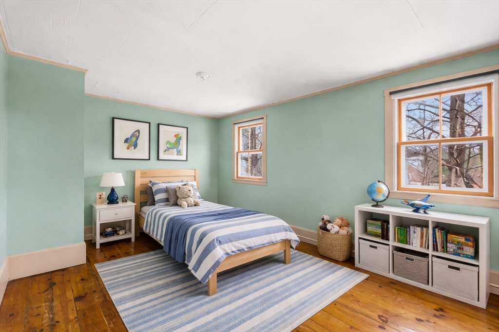 104 Mill Street Groton, MA 01450 - Photo 18 of 30 a bedroom with a bed and wooden floor