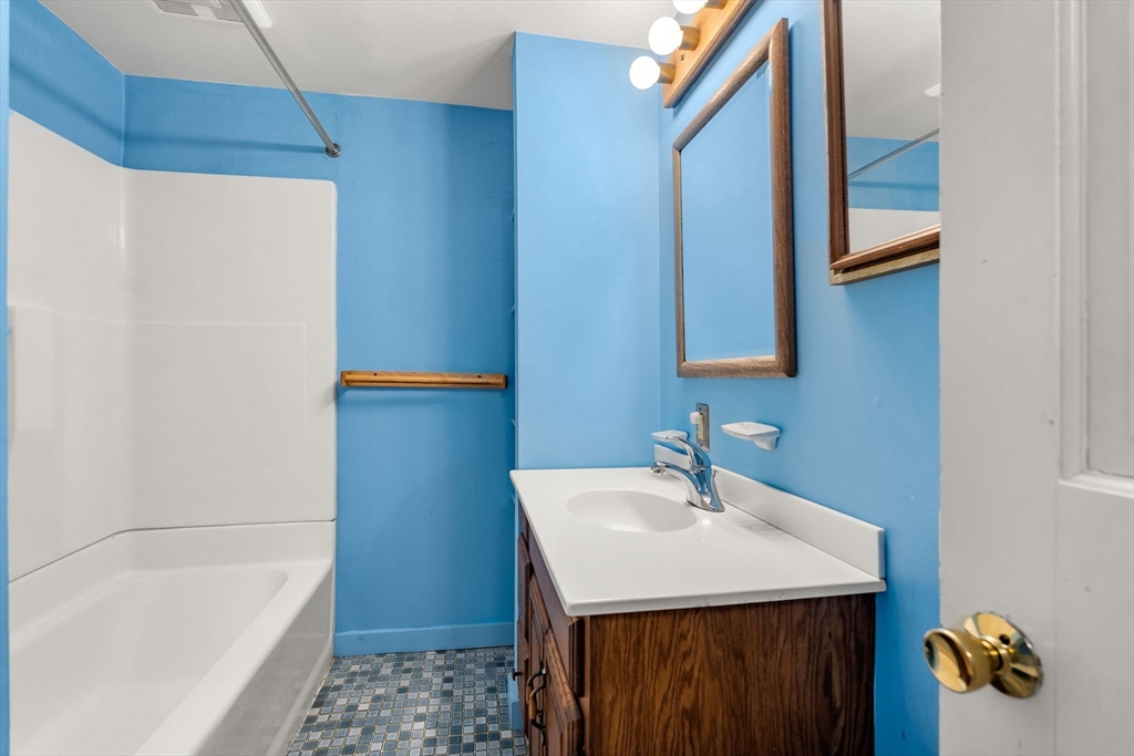 104 Mill Street Groton, MA 01450 - Photo 22 of 30 a bathroom with a sink and a bathtub