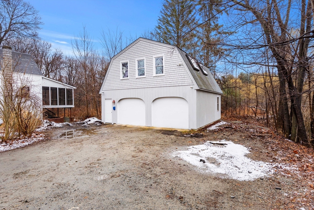 104 Mill Street Groton, MA 01450 - Photo 23 of 30 a view of a white house with a yard covered with snow in front of house