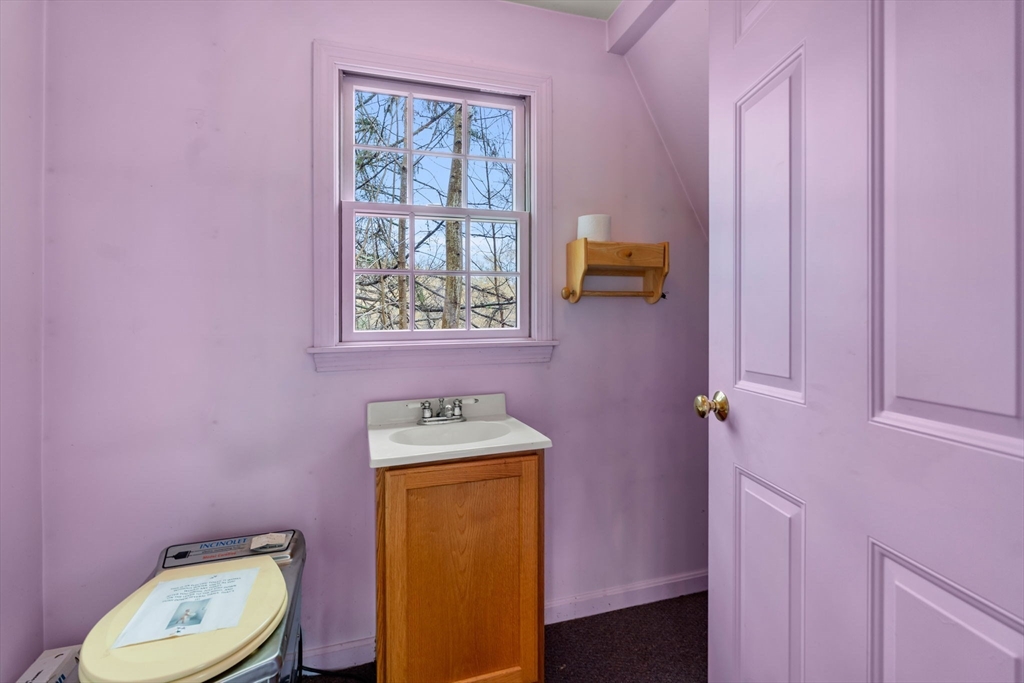 104 Mill Street Groton, MA 01450 - Photo 26 of 30 a bathroom with a toilet a sink and mirror