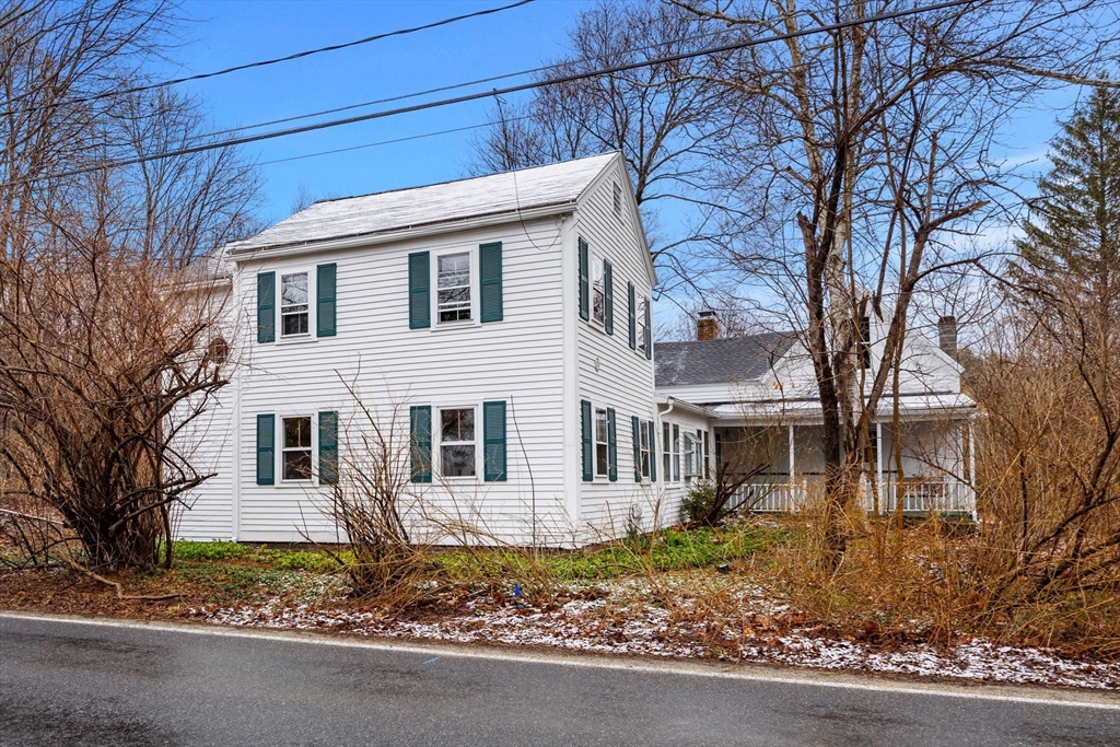 104 Mill Street Groton, MA 01450 - Photo 27 of 30 a view of a white house next to a road and large trees
