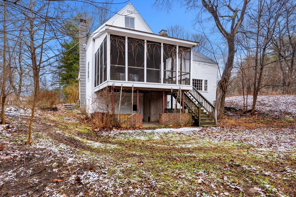 104 Mill Street Groton, MA 01450 - Photo 28 of 30 a view of wooden house with a yard