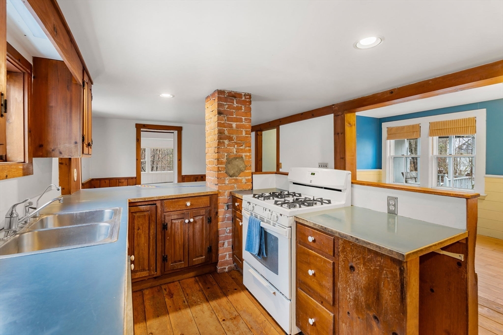 104 Mill Street Groton, MA 01450 - Photo 6 of 30 a kitchen with stainless steel appliances granite countertop a stove and a sink