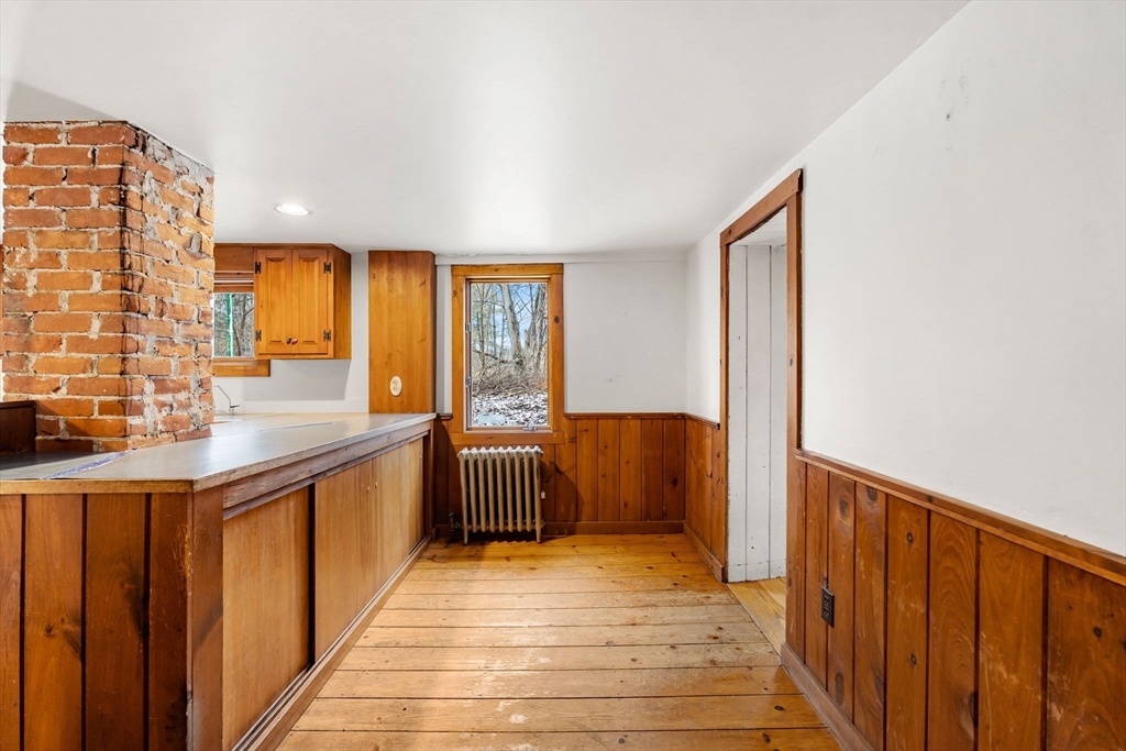 104 Mill Street Groton, MA 01450 - Photo 8 of 30 a view of a kitchen with a sink and wooden floor