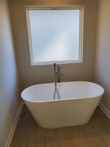 a white tub sitting in a bathroom