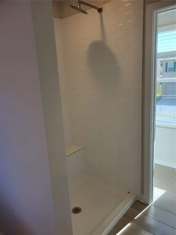 a bathroom with a glass shower door