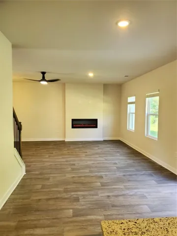 a view of a room with wooden floor