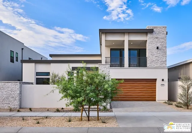 a front view of a house with plants