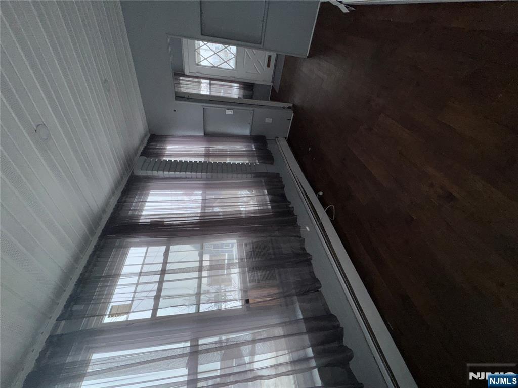 438 4th Street, Unit 1 Carlstadt, NJ 07072 - Photo 2 of 11 wooden floor in an empty room with a window
