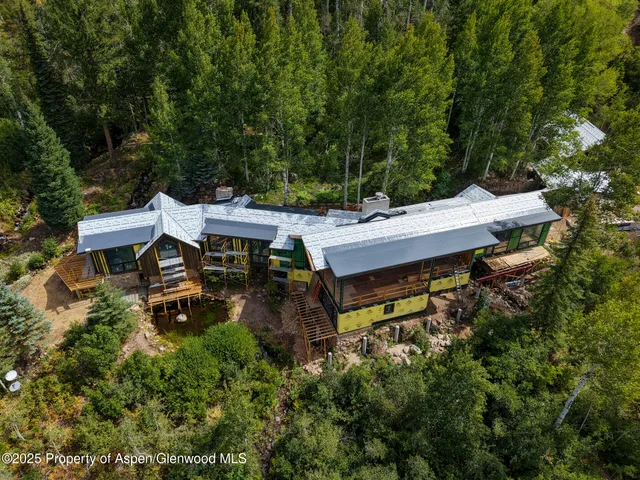 an aerial view of a house with yard and outdoor seating