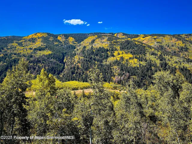 a view of a chairs and table in the balcony