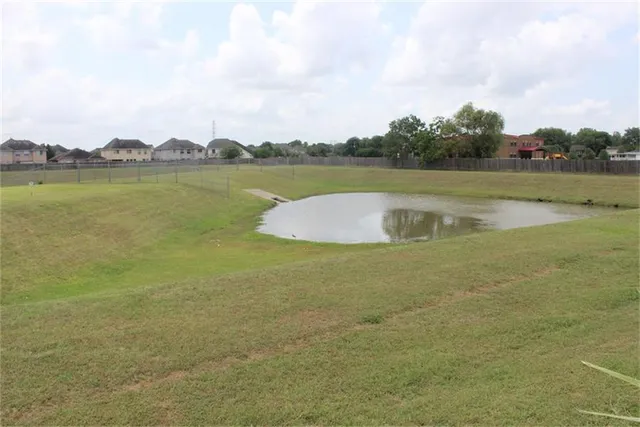 a view of a lake with houses in the background